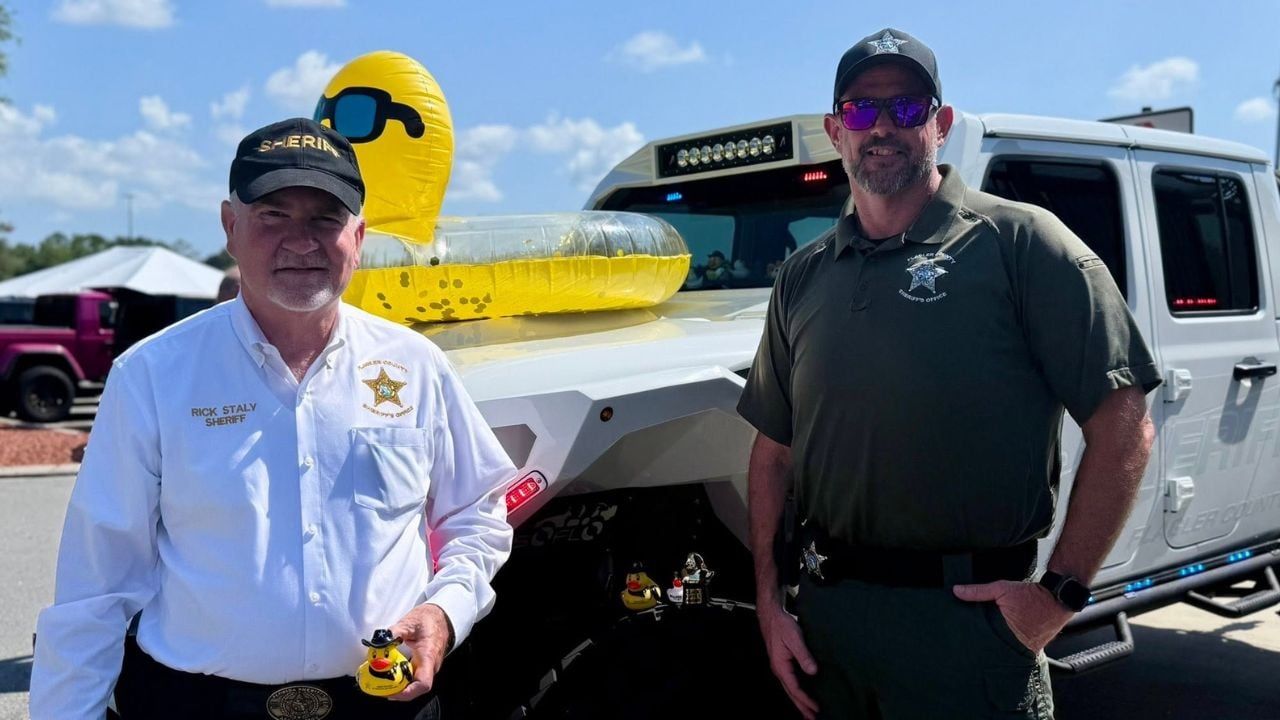 Flagler County Sheriff Rick Staly visits the CMN Jeep Show in Palm Coast surrounded by customized Jeep vehicles.