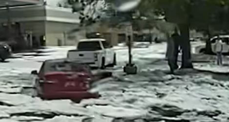 cars stuck in flooded street