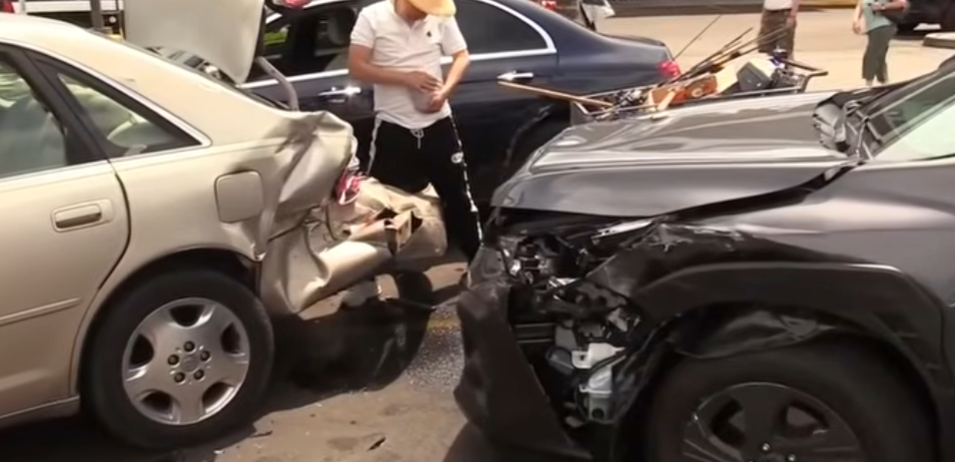 pedestrian pinned under car