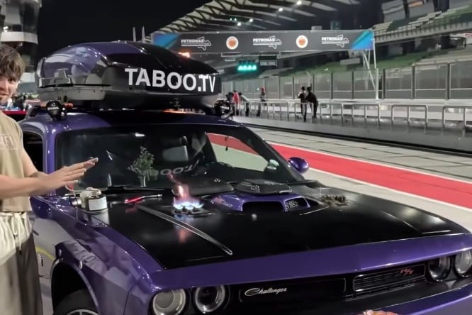 Man Showers at an F1 Circuit Using a Dodge Challenger’s Trunk — There’s Also a Stove on the Hood