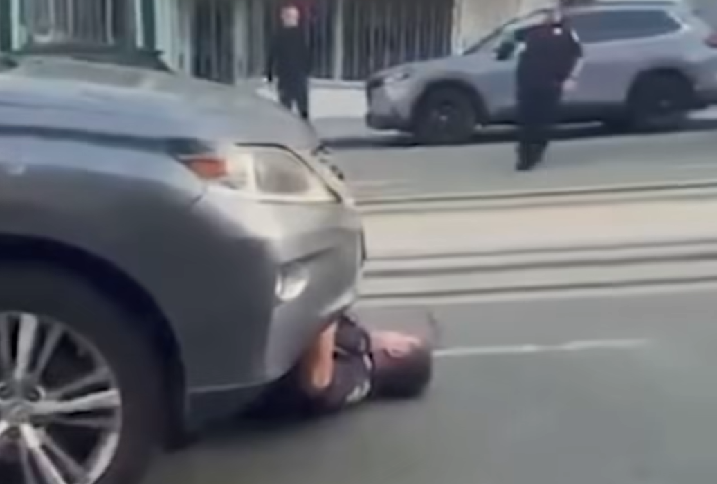 cop pinnned under car