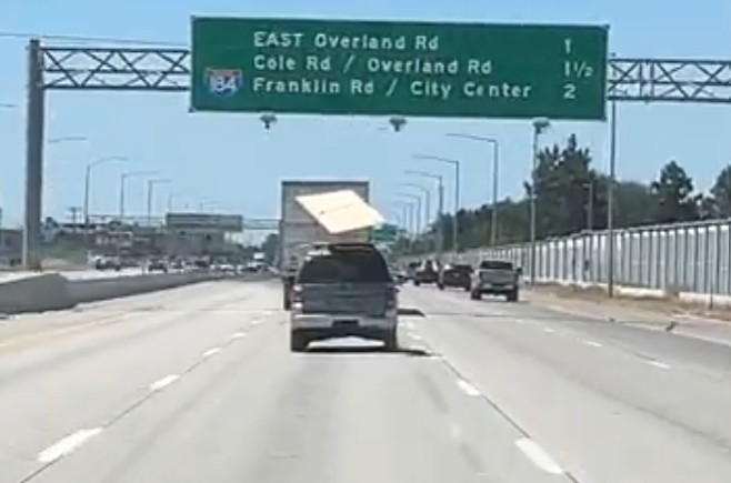 plywood kite caught on highway