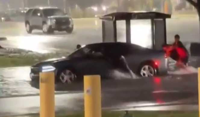 man with sinking car in texas flood