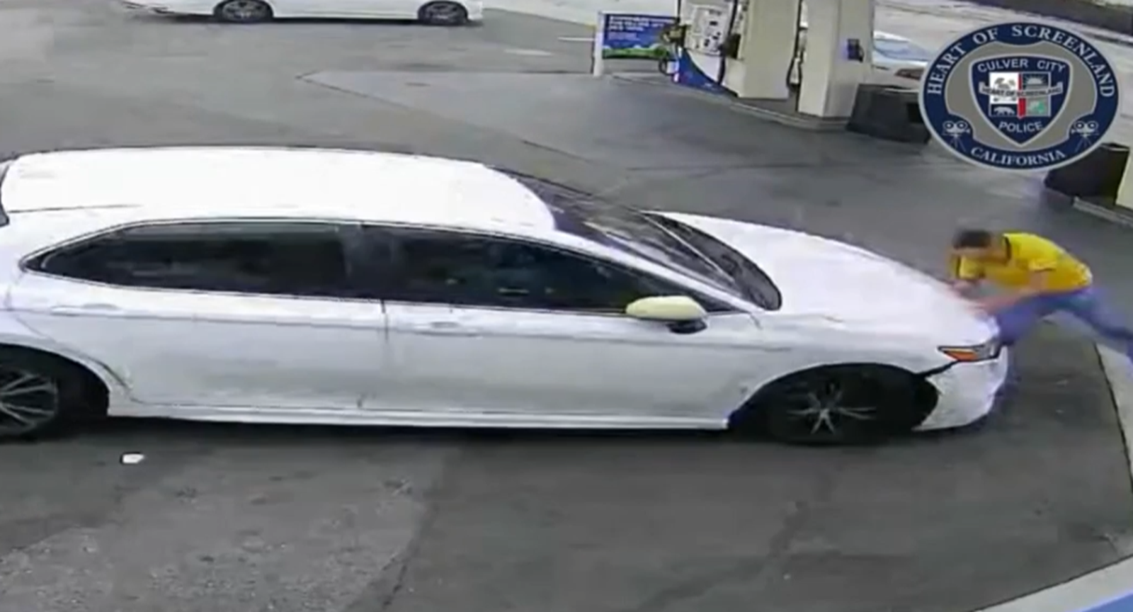 man hits someone at gas station