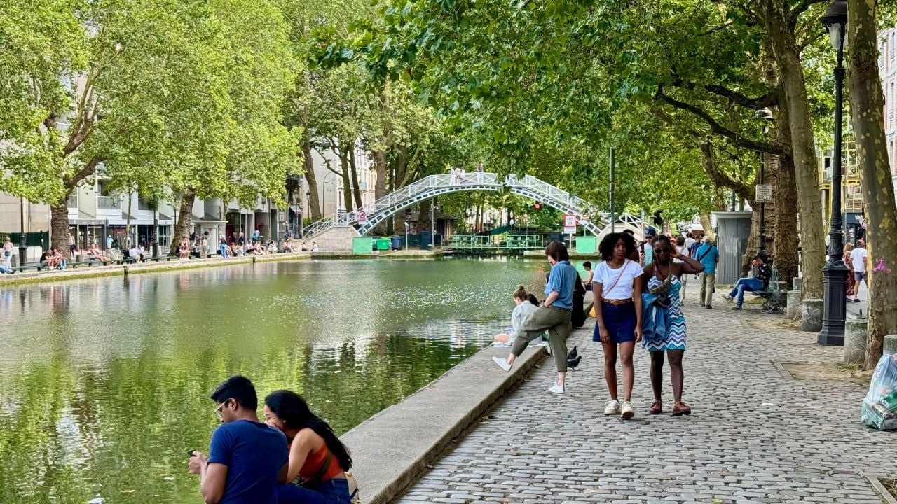 People walking beside Canal Saint-Martin in Paris, France.