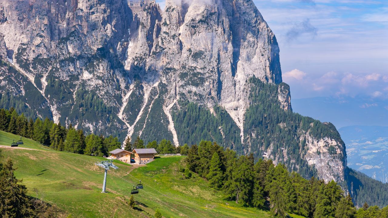 Rugged peaks and green slopes in the Italian Dolomites.