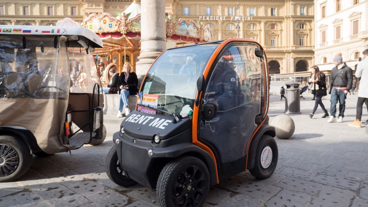 Small rental car parked in Piazza della Repubblica in Florence, Italy