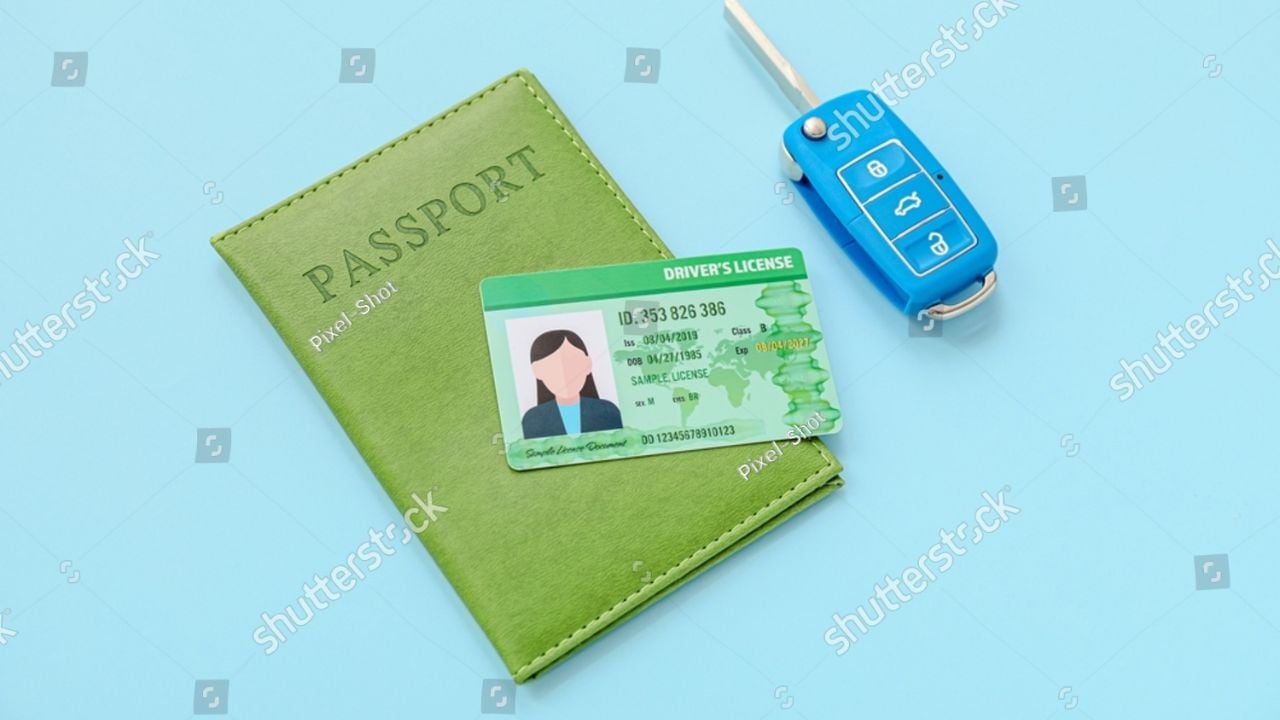 Driving license with car key and passport on color background