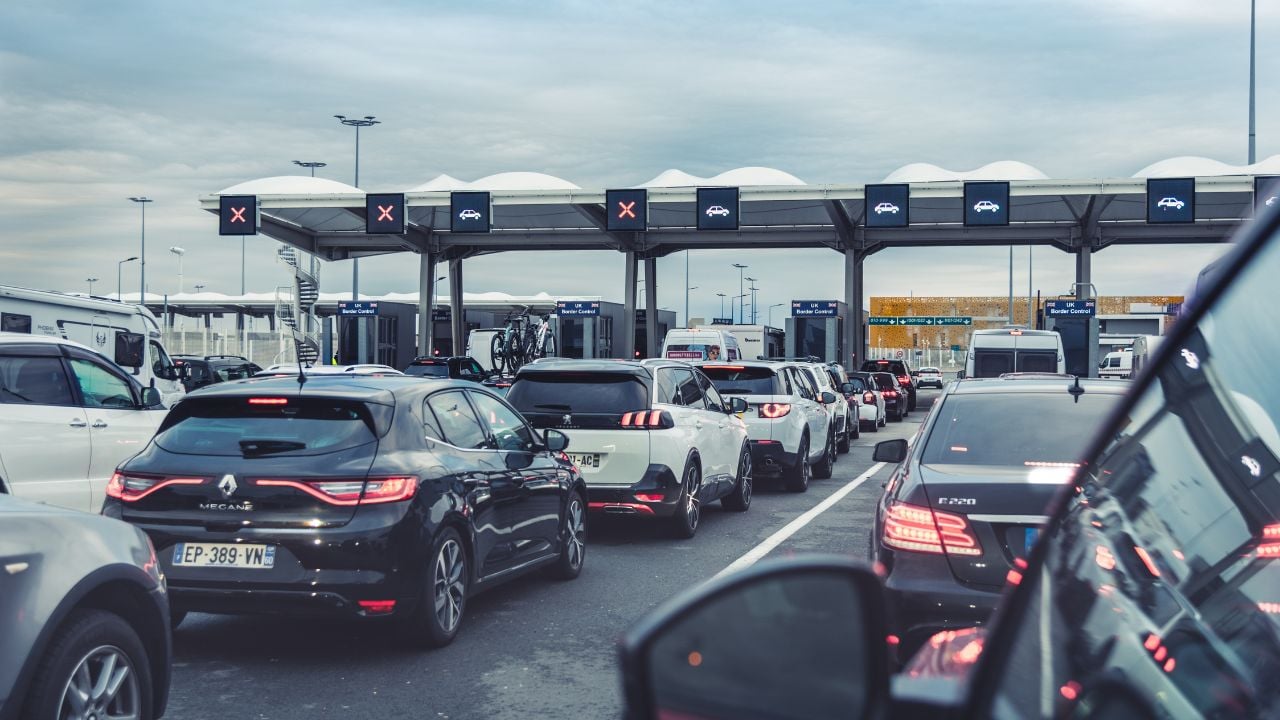 Calais, France 08 31 2024: Cars waiting in queue at France-United Kingdom border checkpoint for embarking at Calais Port Ferry Terminal on holidays. Traffic jam.