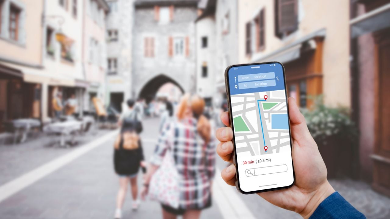 Traveler using a smartphone map for navigation on a city street
