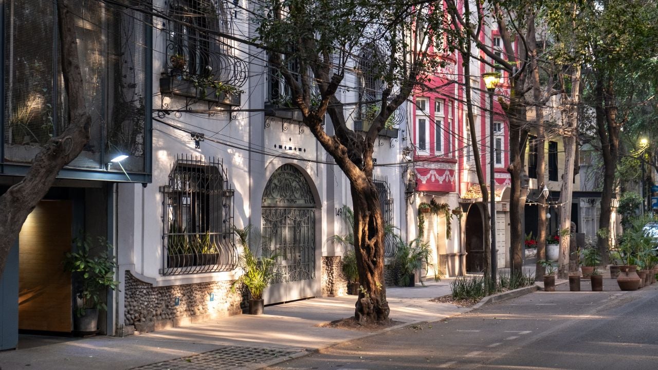 Morning light hits the facades of the art deco style buildings on a street in the trendy neighborhood of La Condesa, in Cuauhtemoc borough of Mexico City