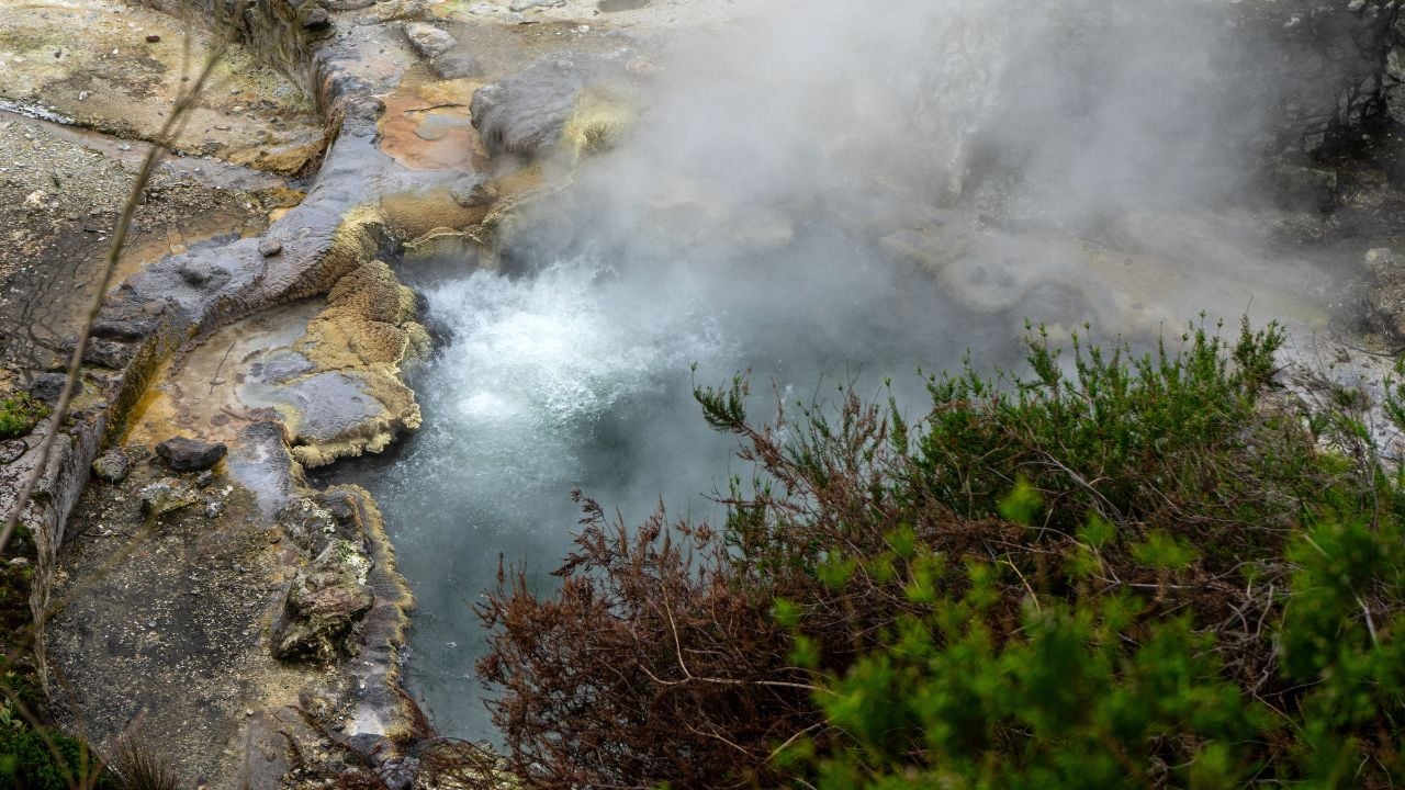 Steam rising from geothermal hot springs in Furnas on São Miguel Island, Azores