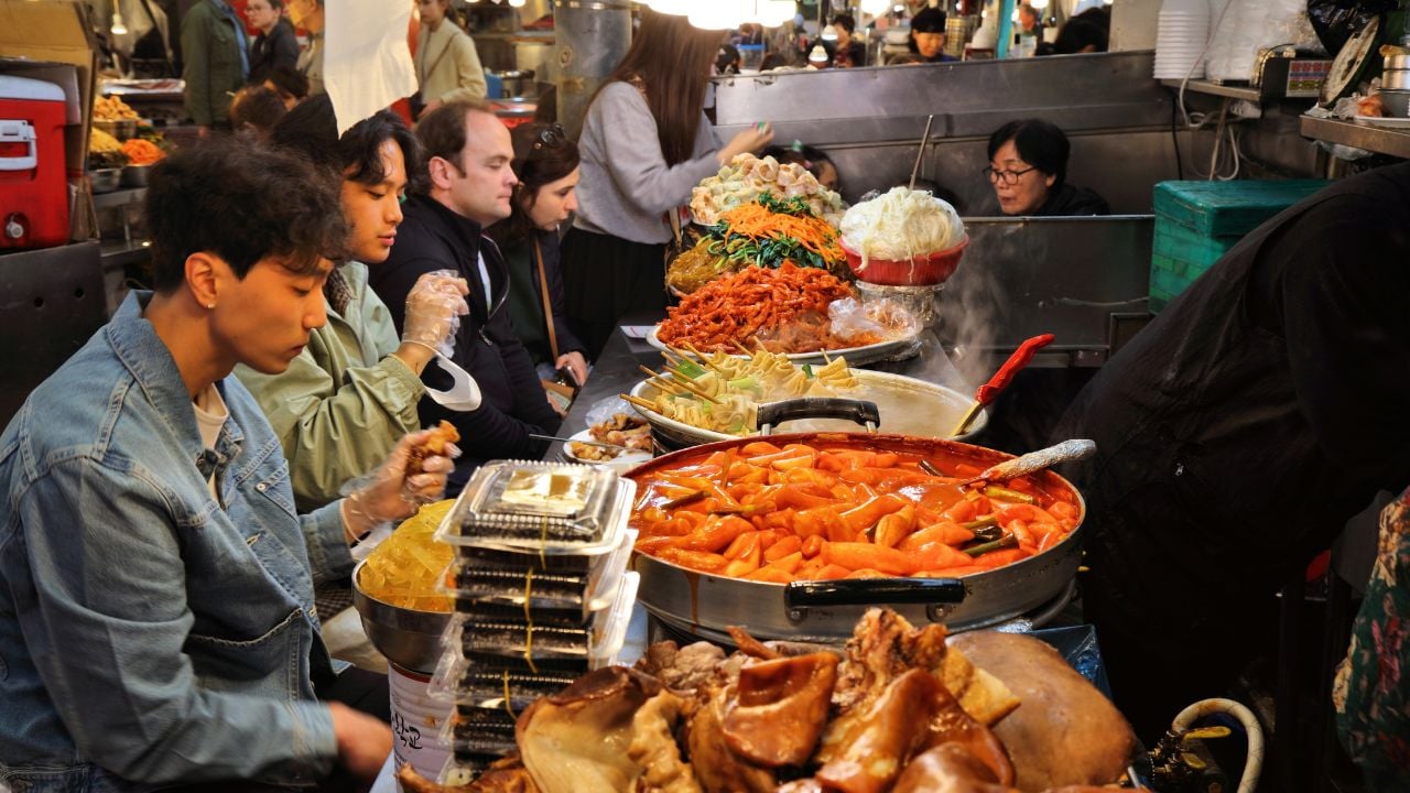 People eating street food at Gwangjang Market in Seoul, South Korea