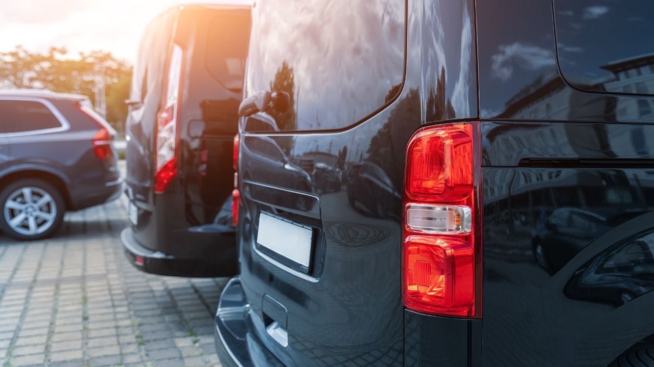 Black passenger vans parked in a row for transportation service