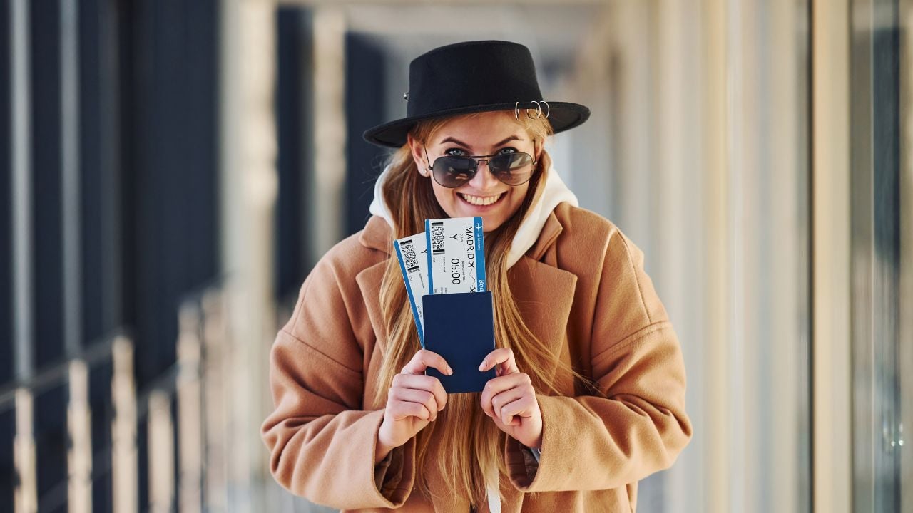 Traveler holding tickets in an airport hall