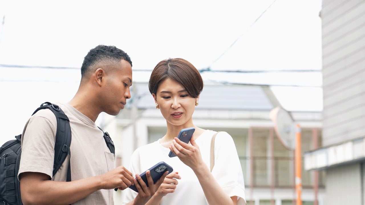 Travelers using a smartphone translation app