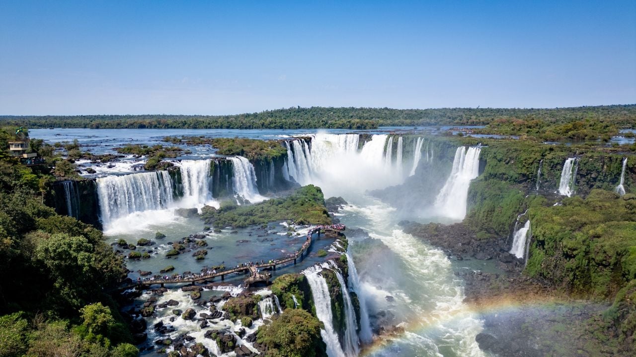 Aerial view of Iguaçu Falls with rainbow mist and visitor walkways