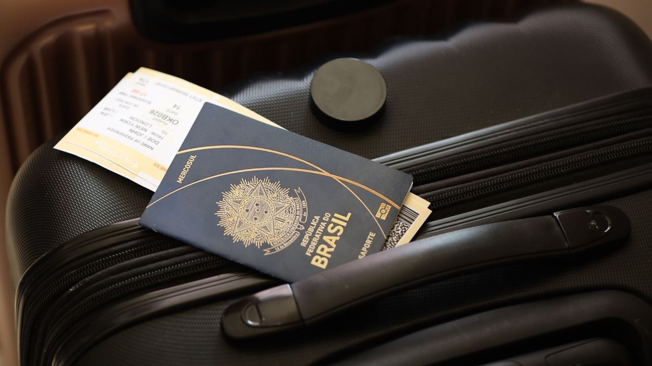 Brazilian passport with travel tickets on a suitcase in an airport