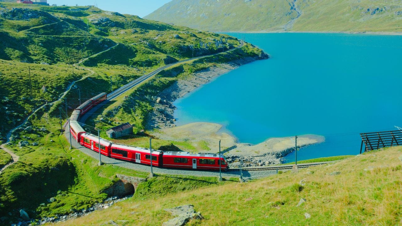 Red Bernina Express train near Lago Bianco and the Bernina Pass in Switzerland