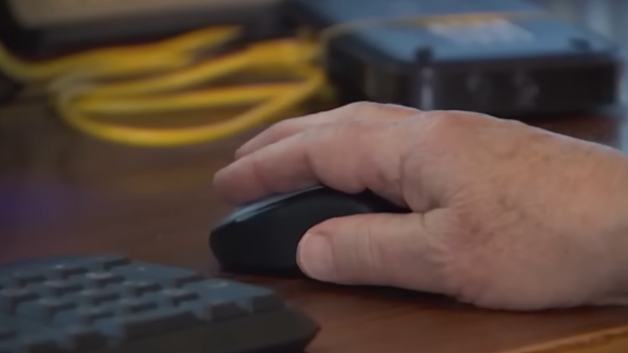 elderly man using computer scam