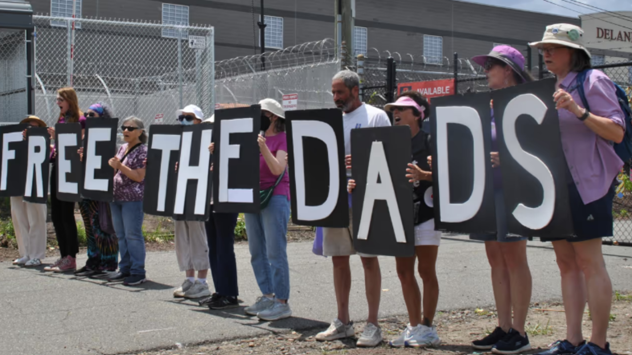 free the dads protesters outside of prison