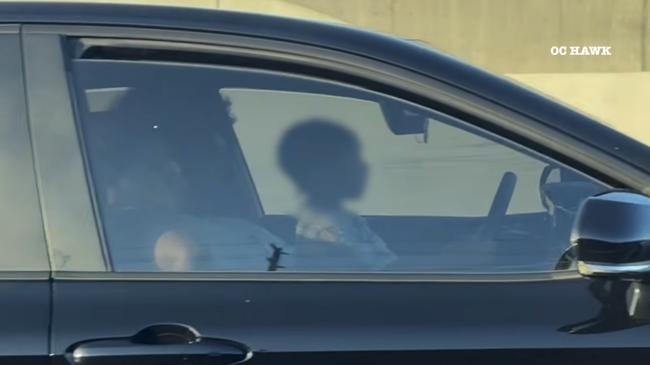 kid driving car on highway