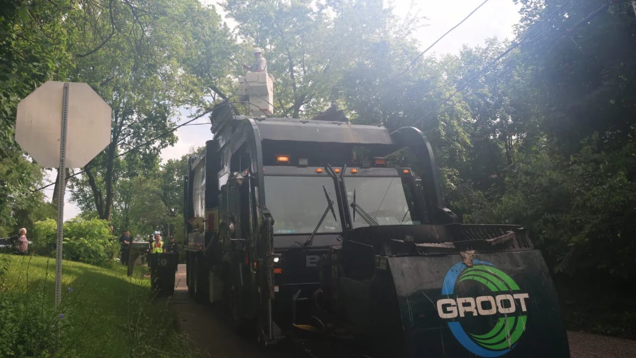 Garbage truck catches on overhead wires, trapping driver and damaging home in Ingleside