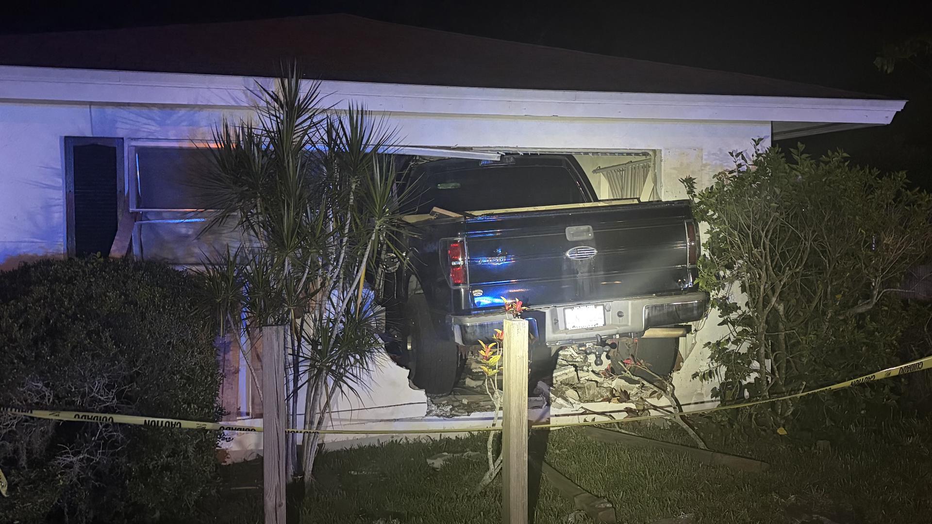 pickup truck crashes into building