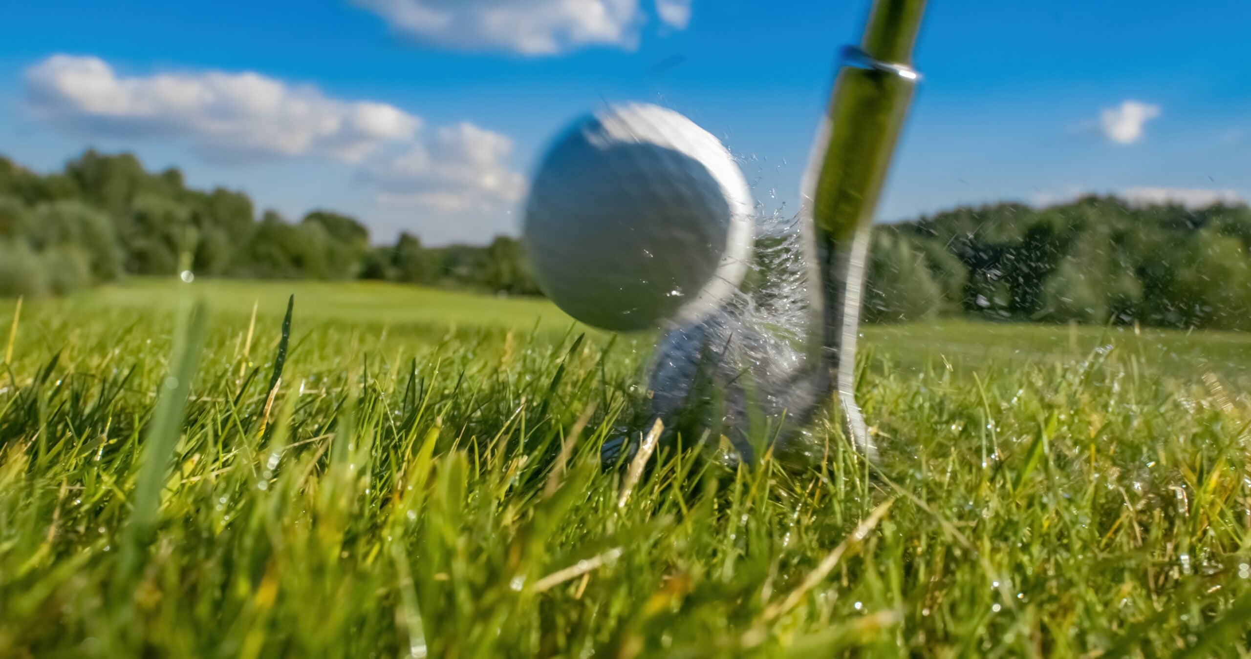 golf club hitting golf ball