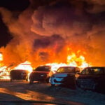 Massive Fire Destroys Dozens of Vehicles at Auto Auction Site, But What Caused It?