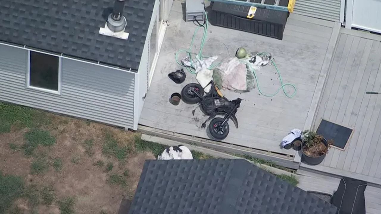 Exploded e-bike lying outside a home after a battery fire forced it out of the house.