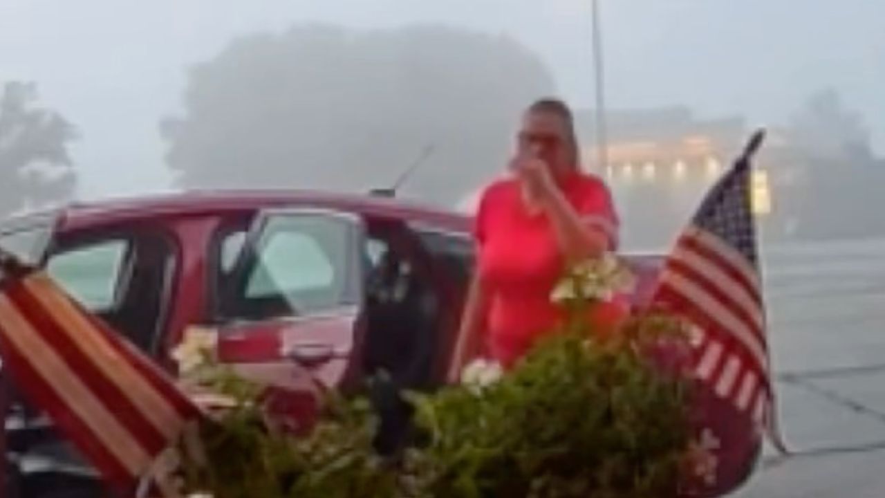 Surveillance video shows a woman digging decorative coleus plants out of planters outside the Shawnee Antique Mall in Shawnee, Kansas.