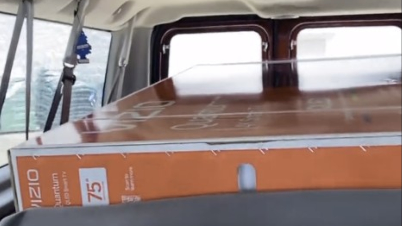 Uber Eats driver delivers a TV