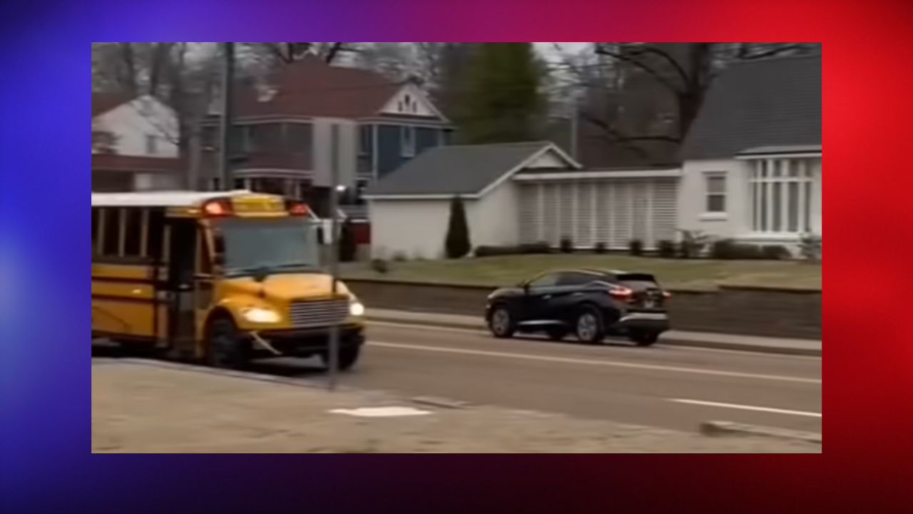 car drives past school bus