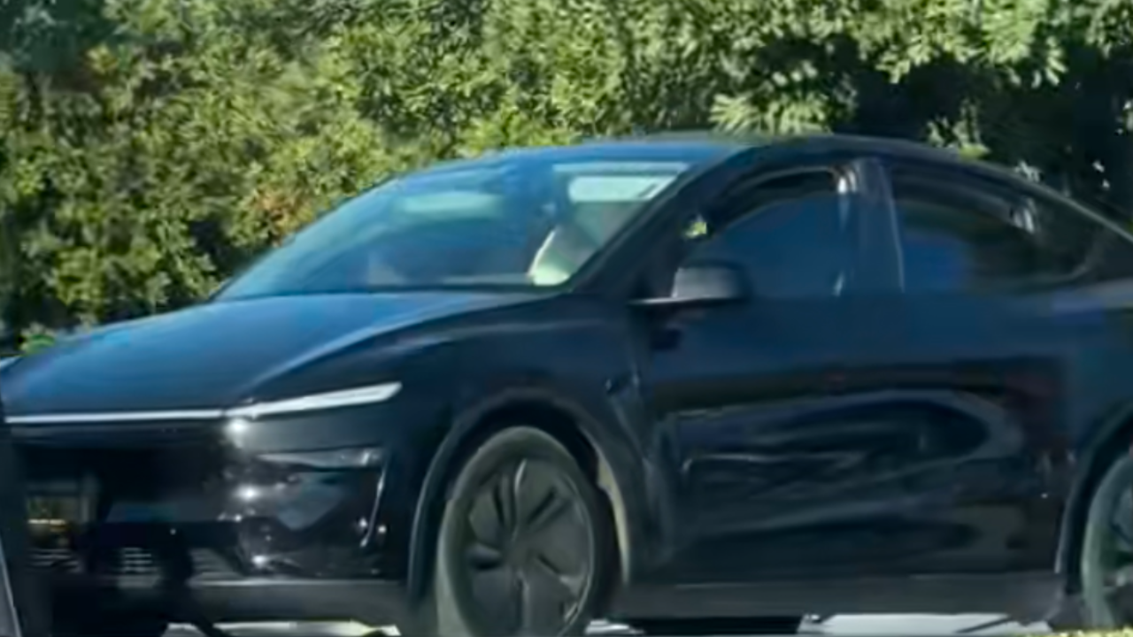 tesla getting towed with dog inside
