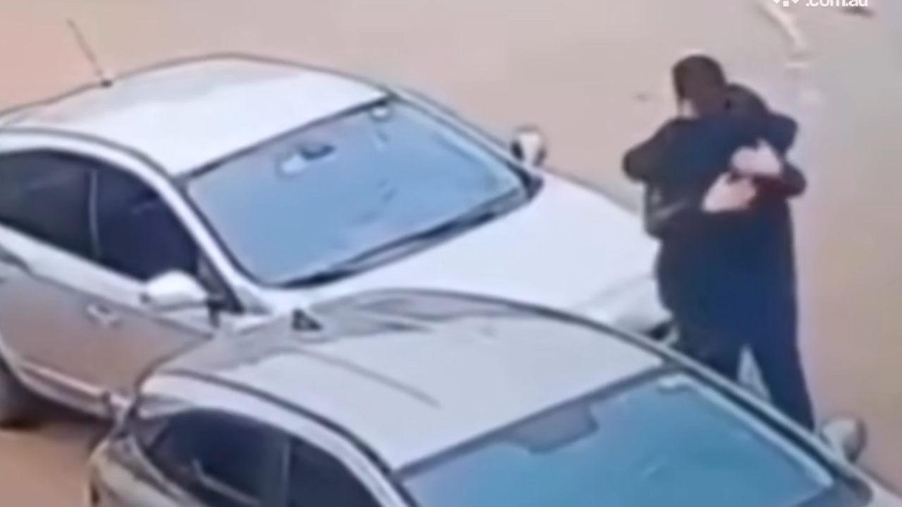 two men hug after car accident