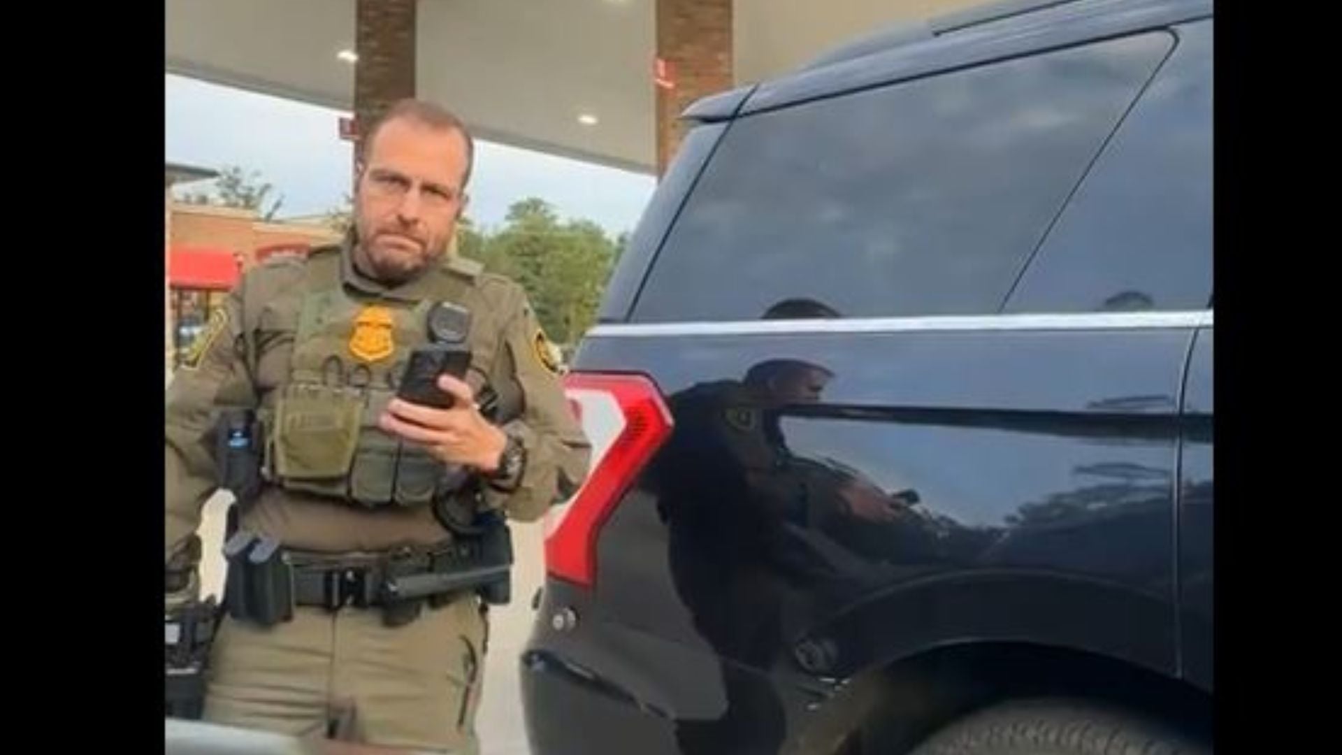 Border patrol agent interrogates driver.
