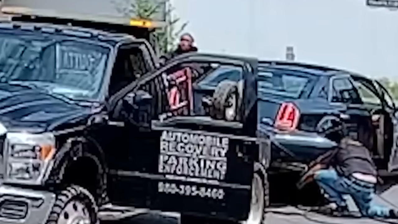 tow truck arrested for towing car with passengers