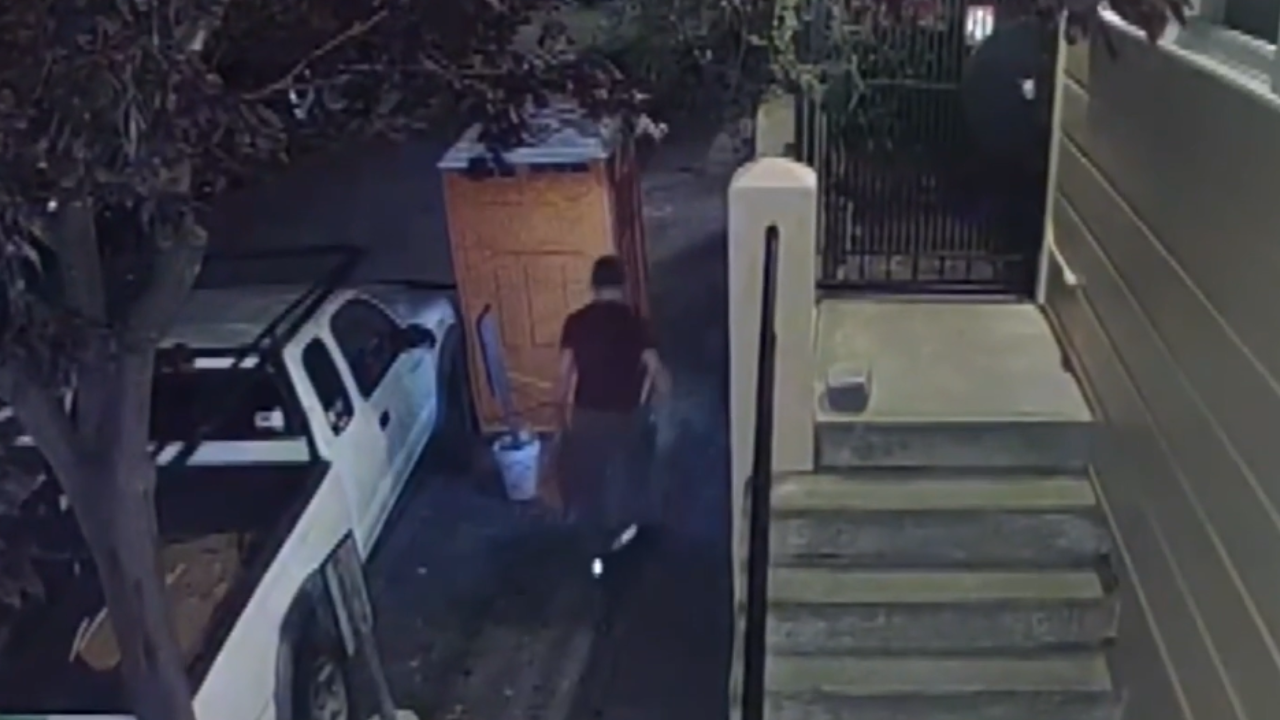 man stealing sewer grates