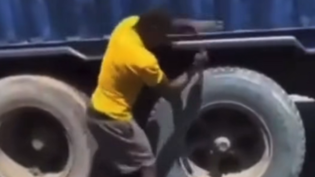 man popping truck tires