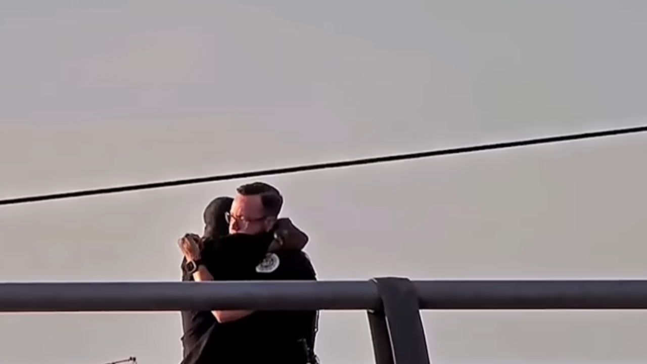 cop hugging man he saved from jumping off bridge