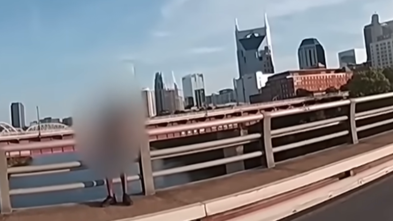 man talked down from ledge on bridge