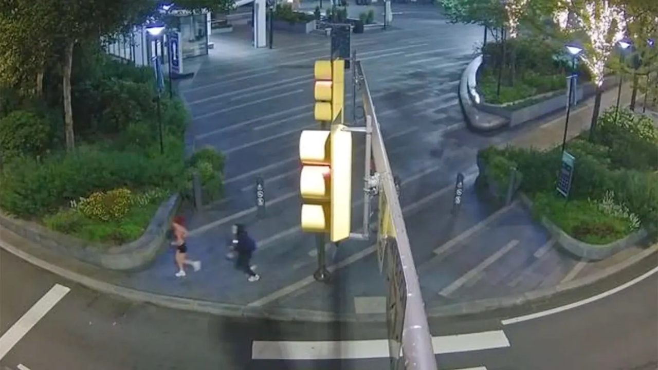 man in creepy doll mask chasing runner