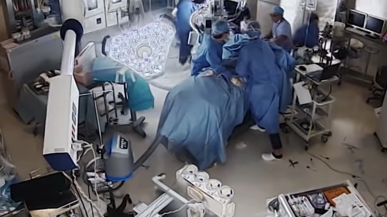 surgeons hold patient