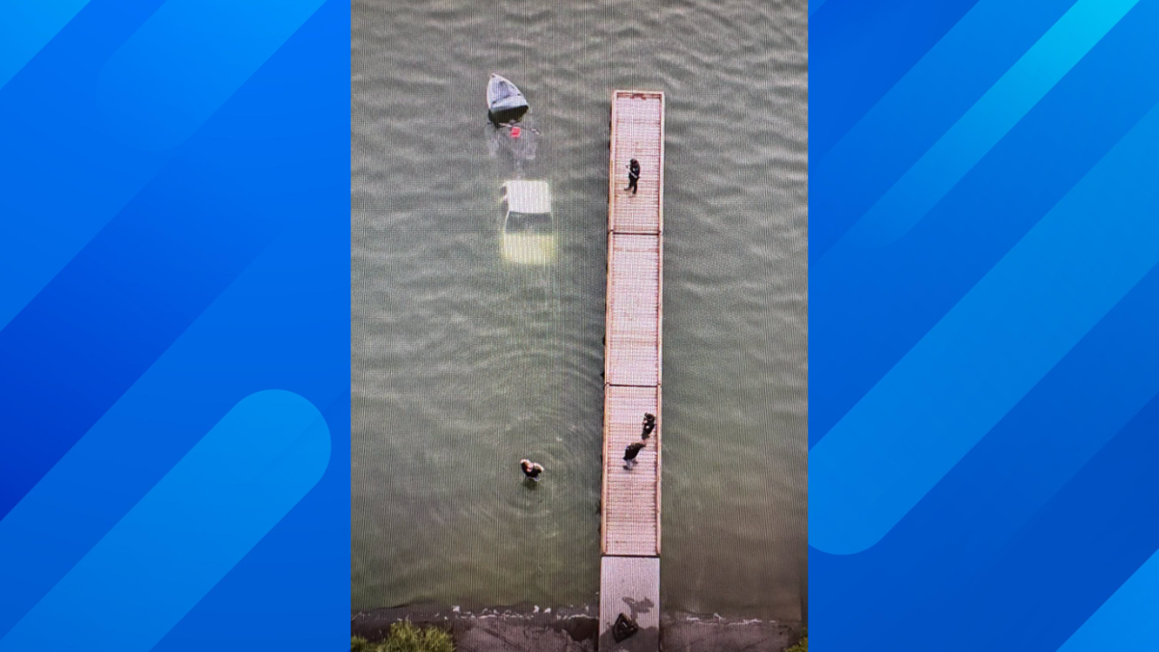 truck submerged off dock in water