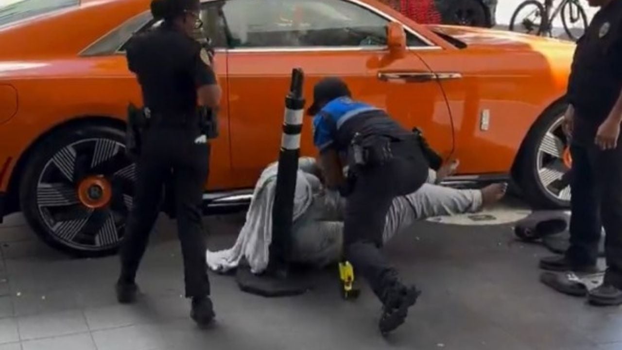 Man entering woman's Rolls-Royce Taser
