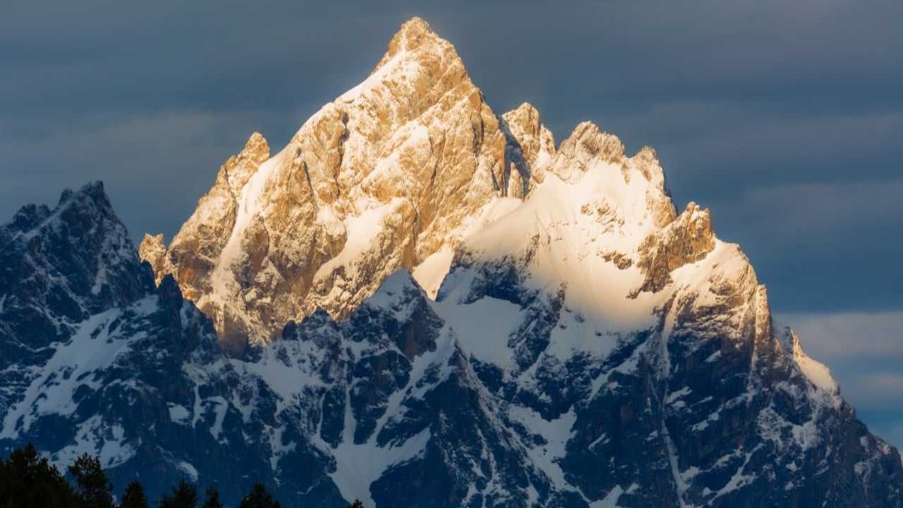 sunlight hitting grand teton in wyoming