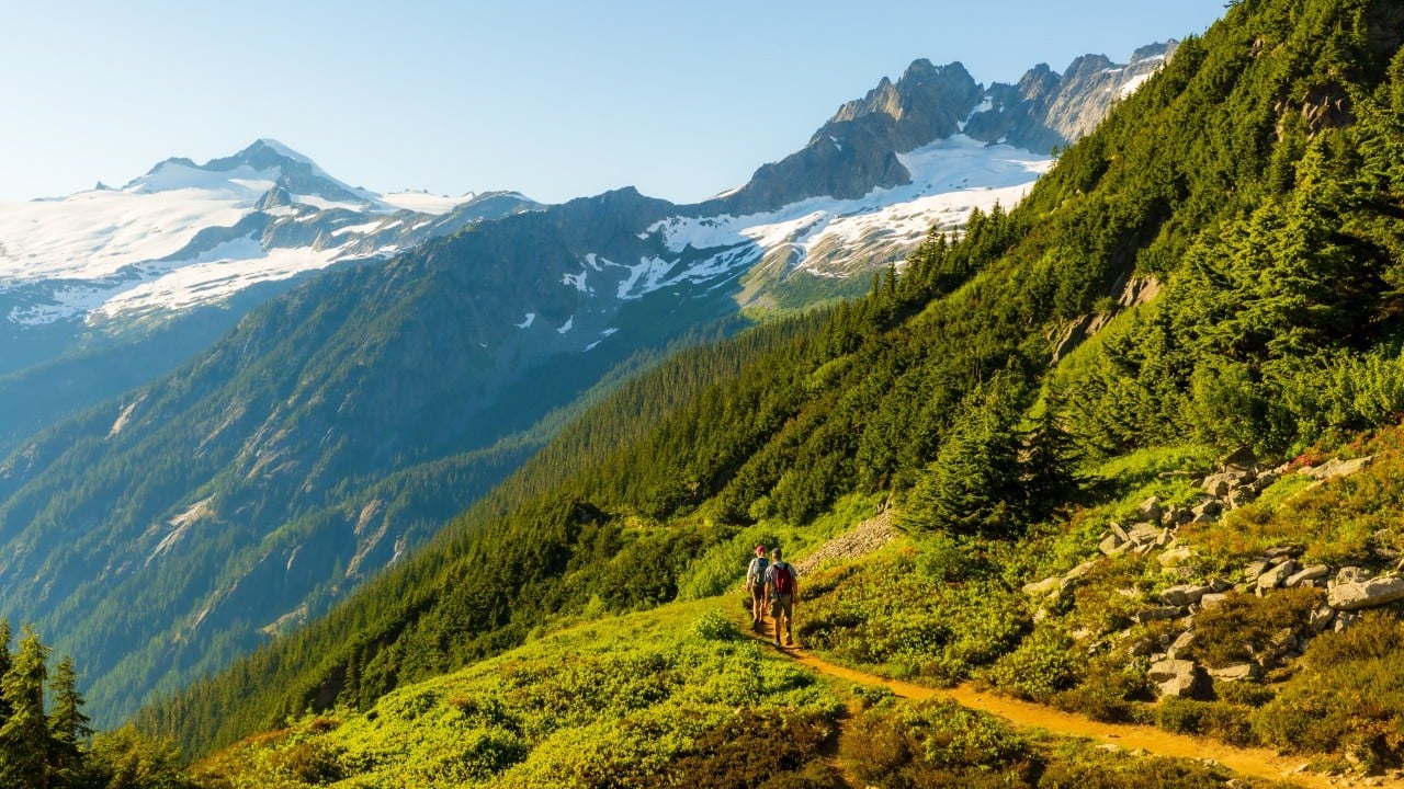 two hikers on the trail in washington