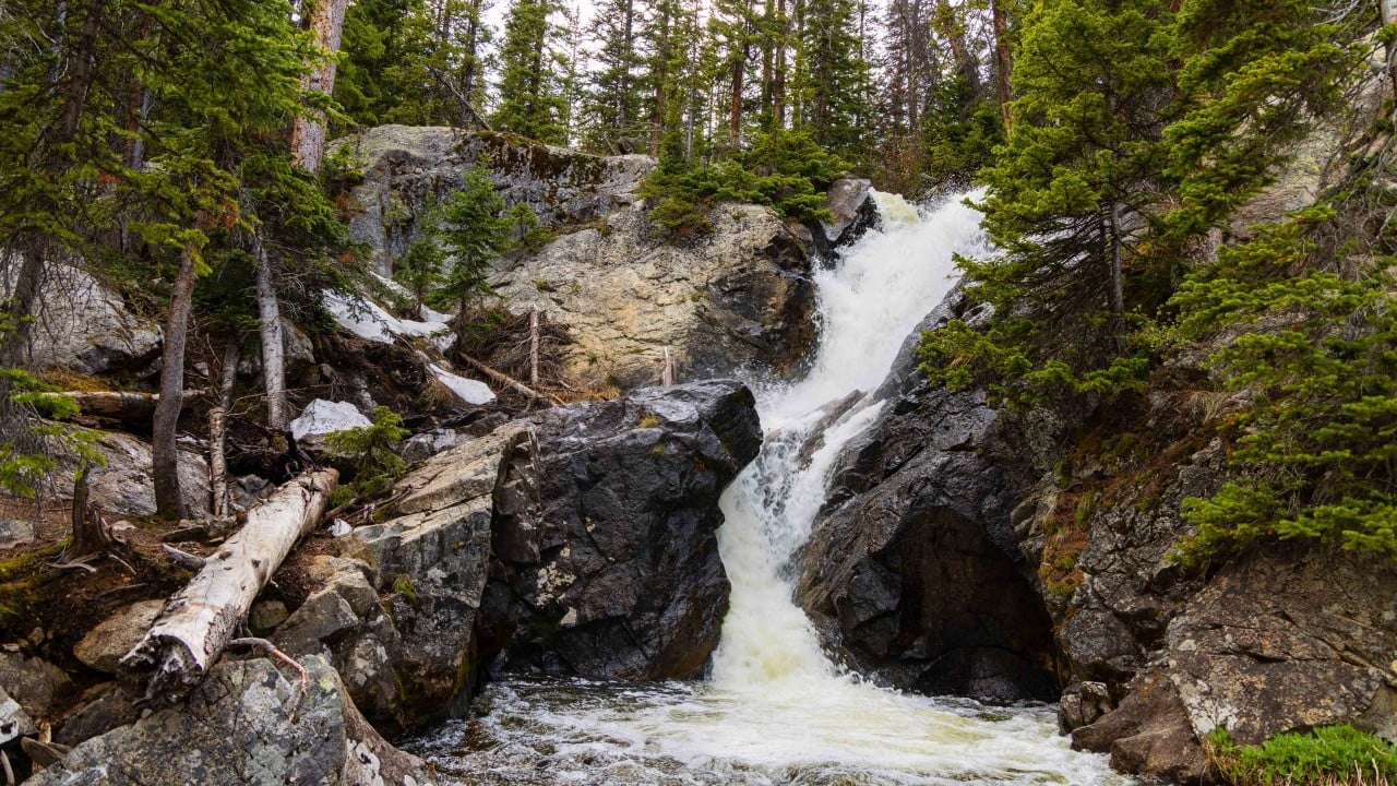 a waterfall with trees surounding it