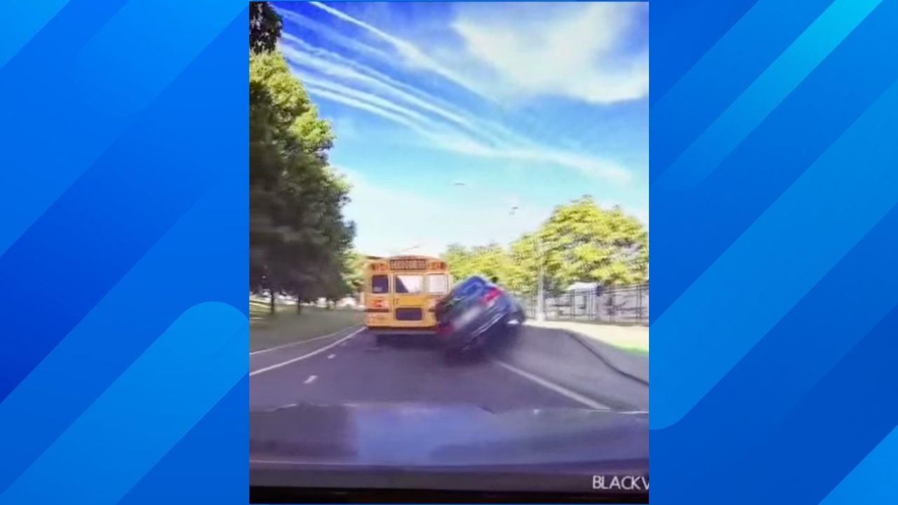 Car hits school bus and concrete wall